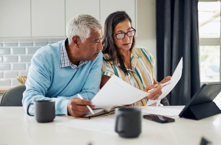 Older couple reviewing estate plan documents together at home, highlighting the importance of updating estate plans regularly