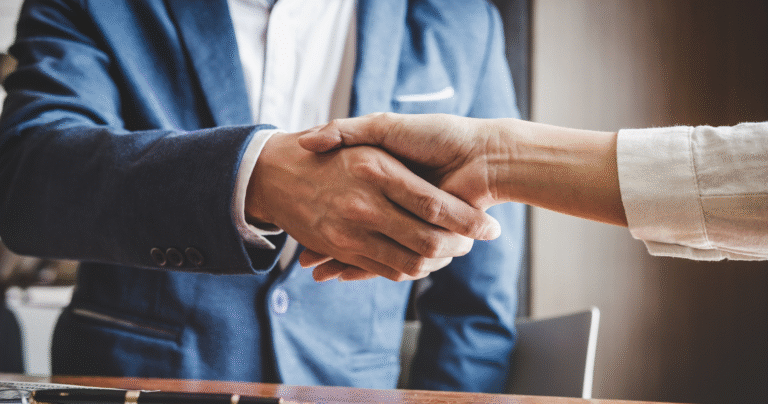 Professional handshake symbolizing trust and partnership in managing diversified investment portfolios.